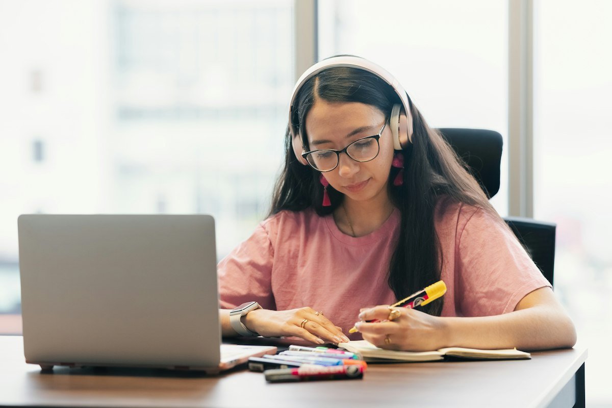 Student practising French with headphones